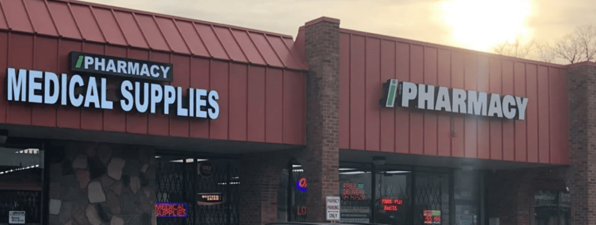 A red building with two signs on it's side.