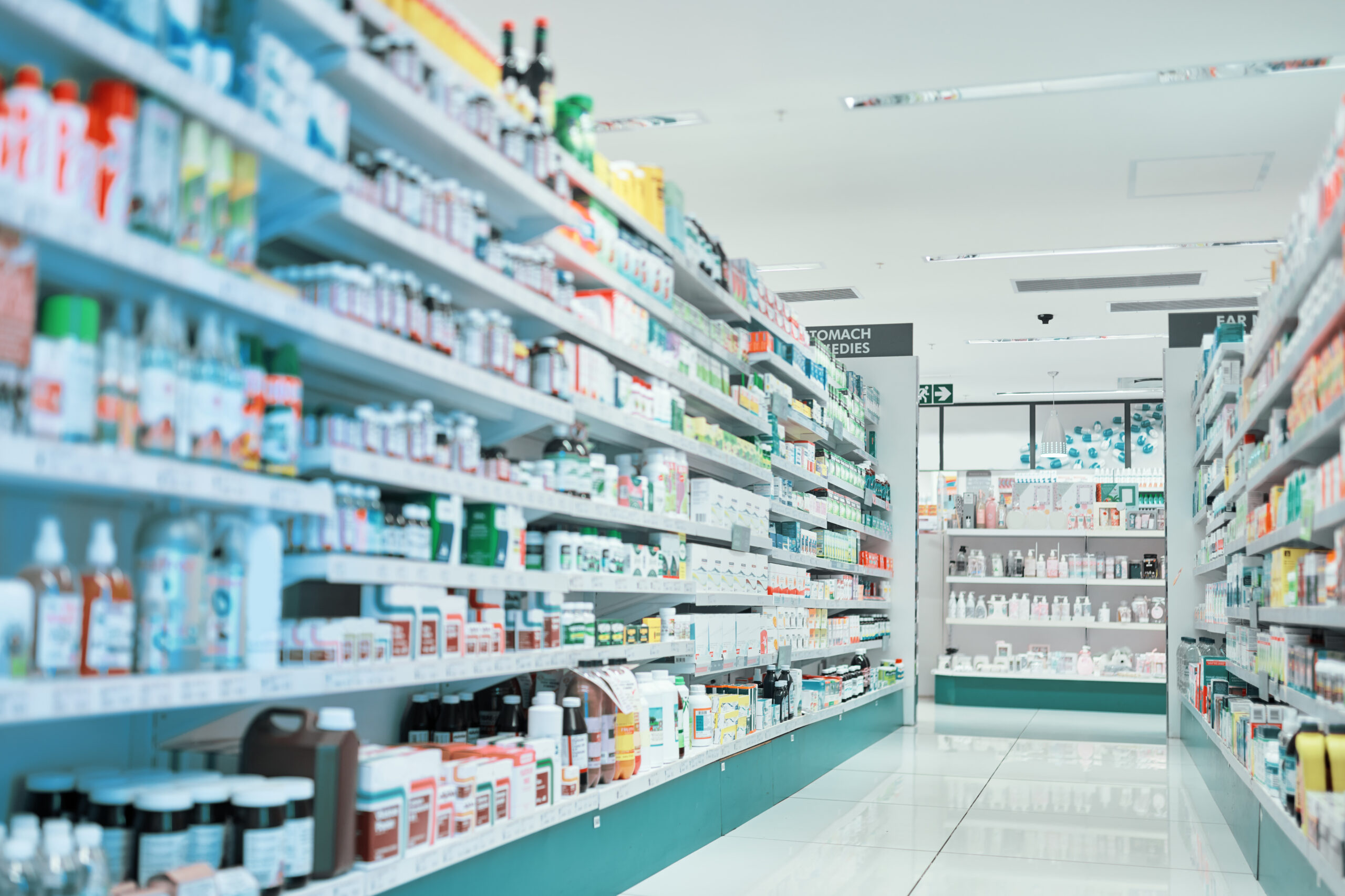 A pharmacy with many shelves of medicine and bottles.