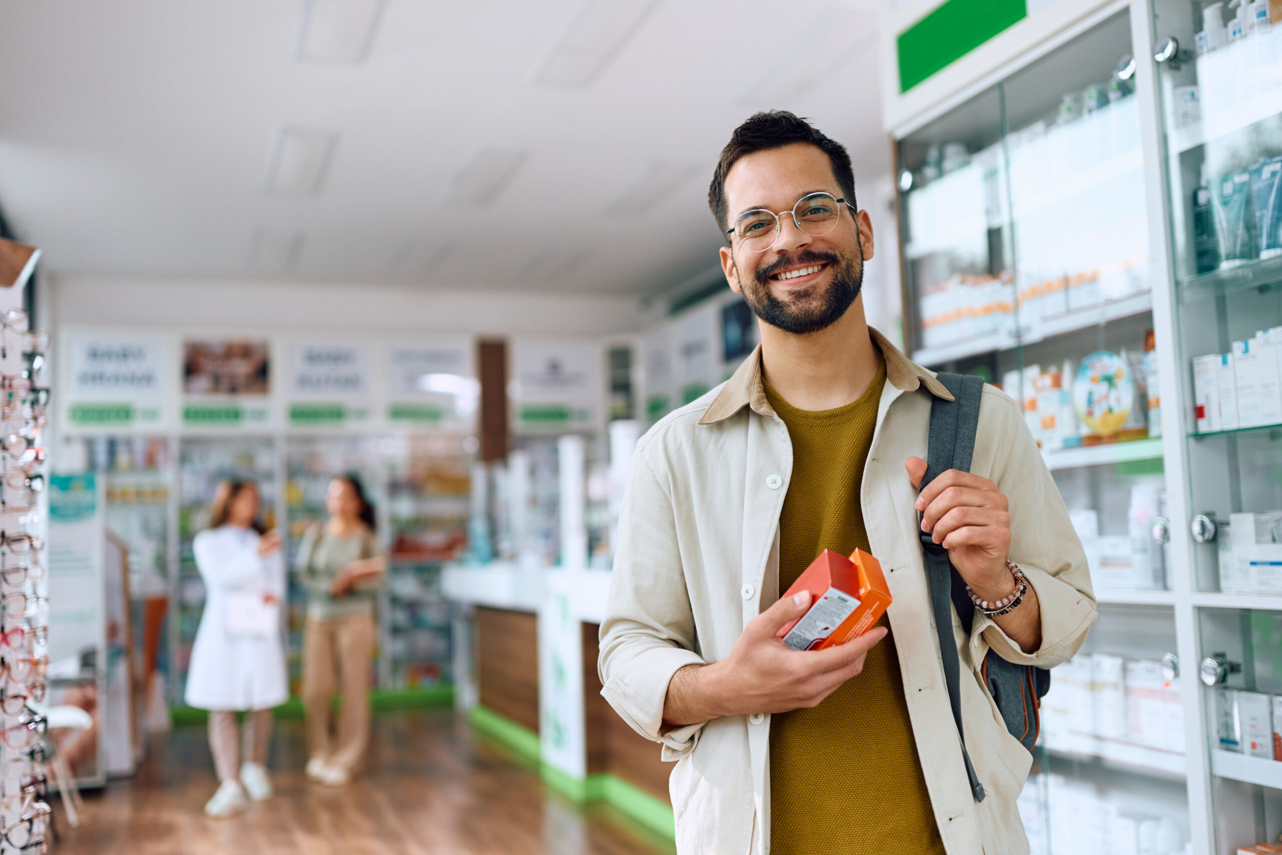 A man holding an orange box in his hand.